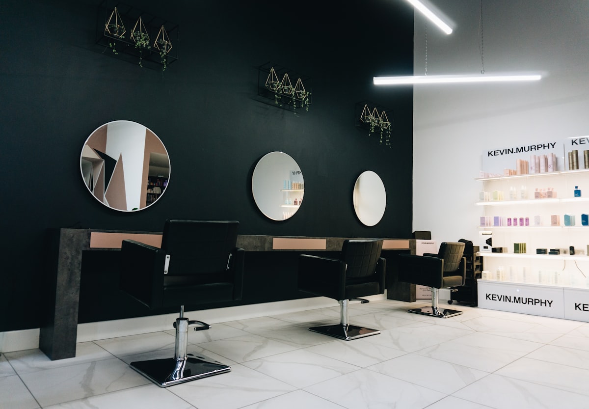 Dark salon interior with round backlit mirrors