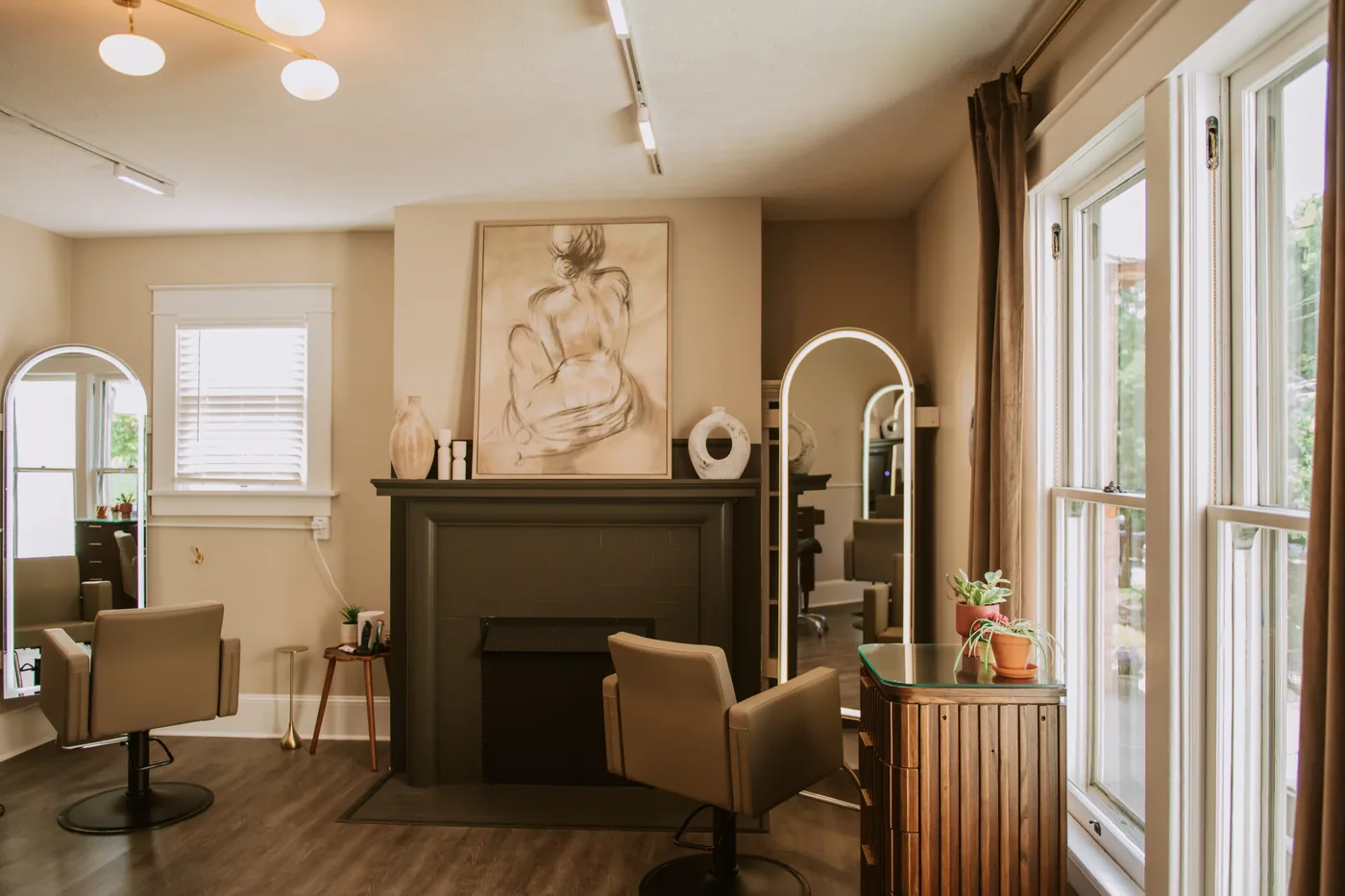 Fireplace mantel and arched mirror at Patina Salon — beauty that deepens with time