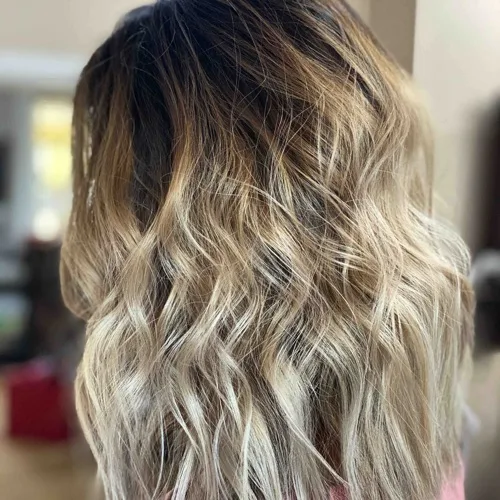 Rooted blonde balayage blended to a cool, icy finish