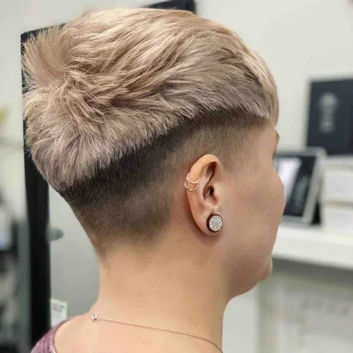 Cropped cut with a tapered fade and soft blonde
